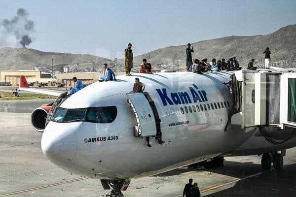 People climbed on top of a plane at Hamid Karzai International Airport in Kabul, Afghanistan, on Monday.